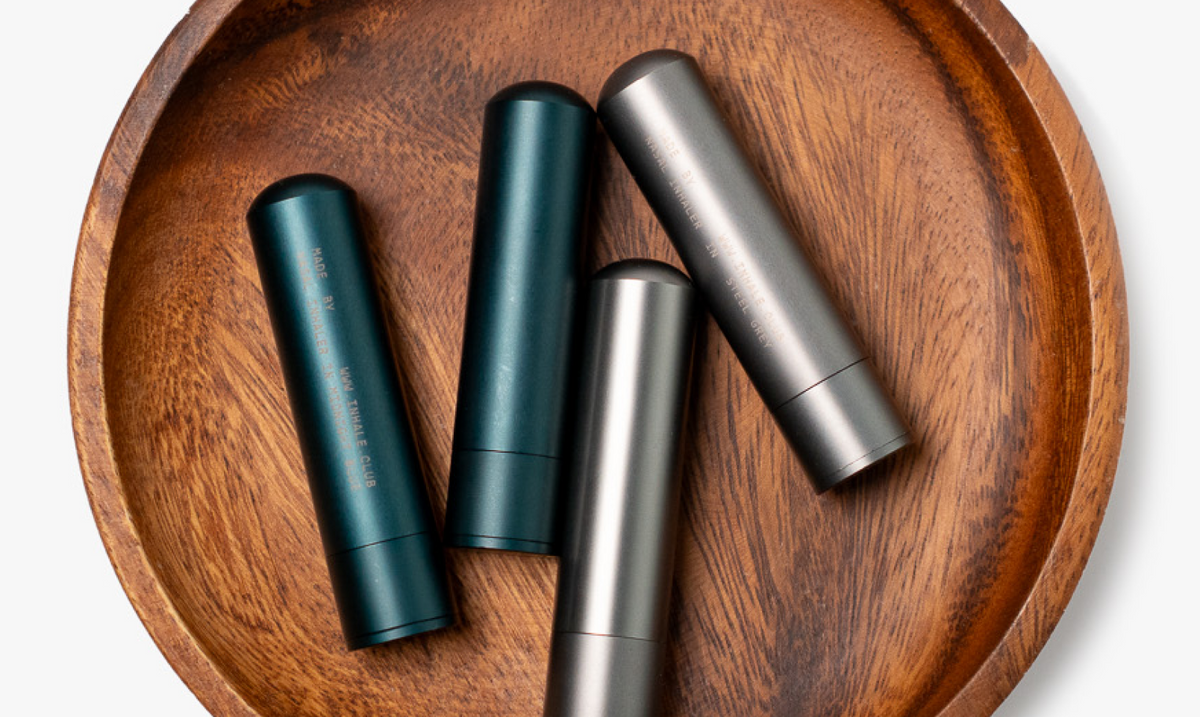 Aluminium nasal inhalers resting in a wooden bowl
