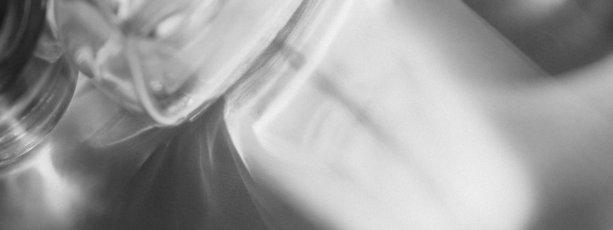 Soft-focus glassware catching the light, black and white