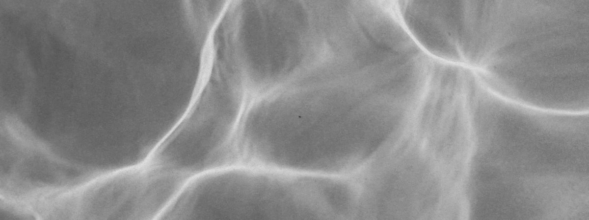 Sunlight rippling across the surface of water, black and white