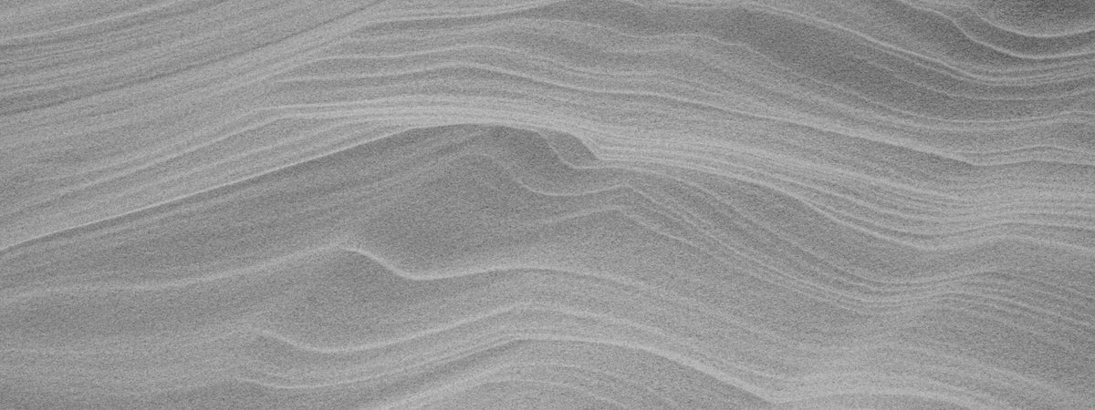 Wind-rippled sand in soft light, black and white